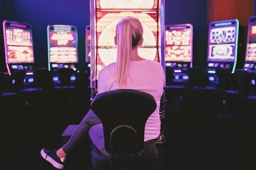 Player at a row of video slots in a casino